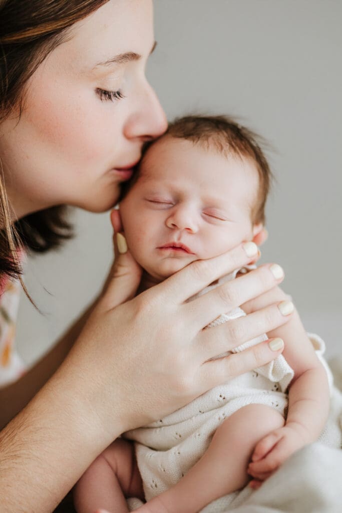 Parents cuddling their newborn during a relaxed Louisville newborn photography session.