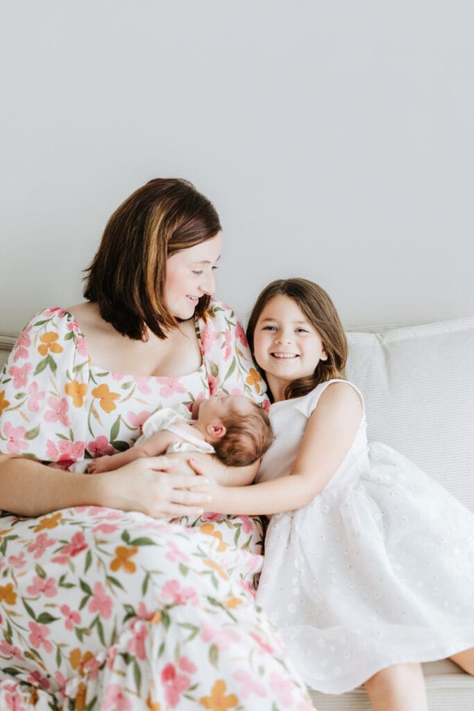 Parents cuddling their newborn during a relaxed Louisville newborn photography session.