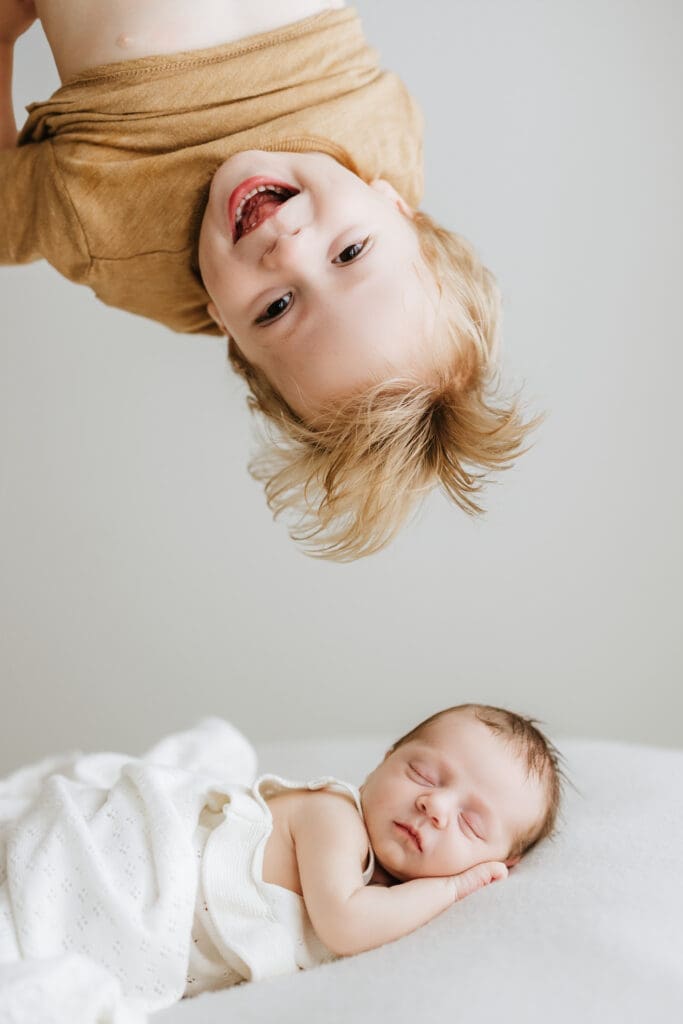 Parents cuddling their newborn during a relaxed Louisville newborn photography session.